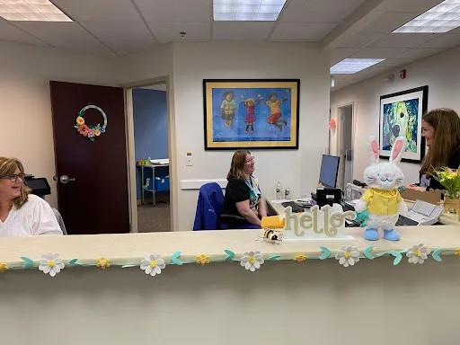 office workers in a pediatric front desk