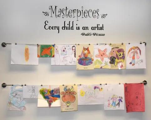 handdrawn pictures hanging on a wall